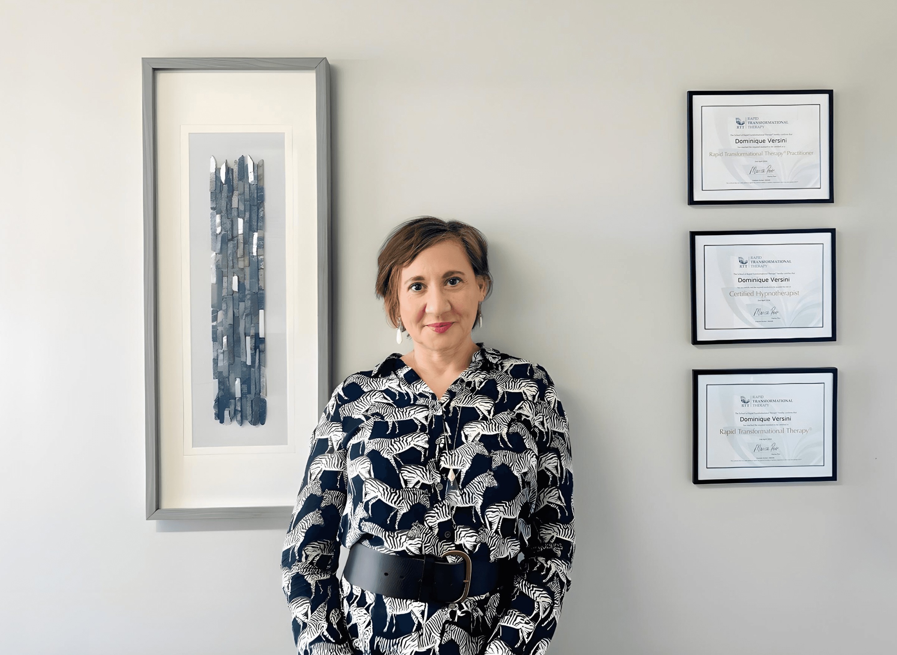 Dominique with certificates and artwork